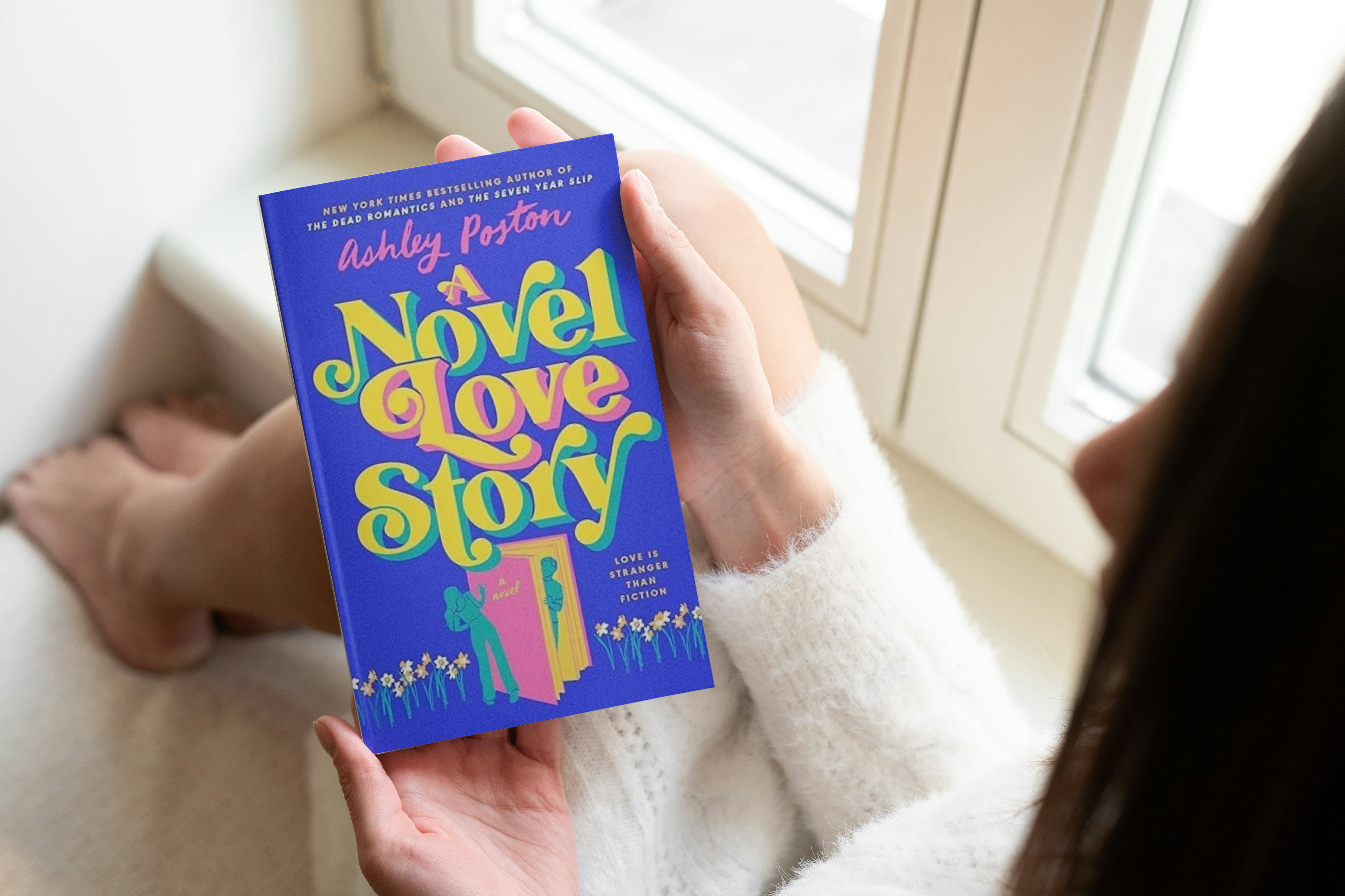 an image of the book a novel love story by ashley poston being held in a woman's hand as she sits by a windowsill