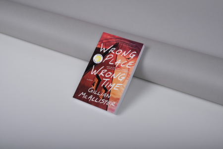 photo of book wrong place wrong time by Gillian McAllister leaning against a wall