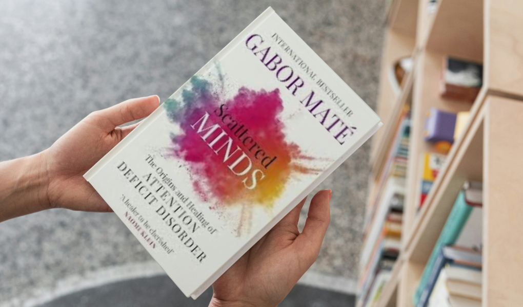 photo of person holding book scattered minds by Gabor Maté