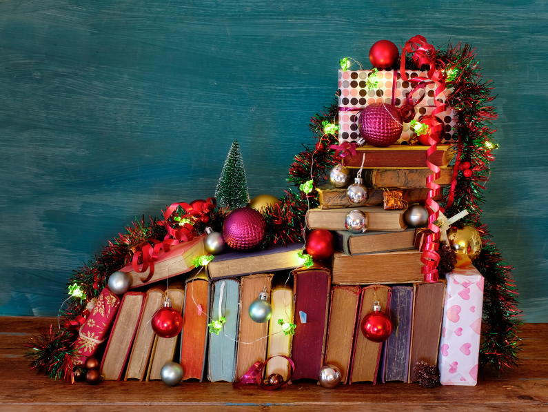 photo of various books with christmas ornaments and decorations for December 2024 book releases