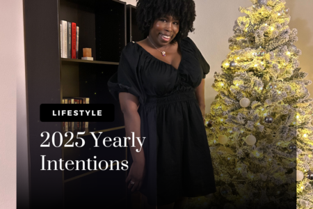 photo of kathleen haagenson wearing a black dress posing in front of bookshelves and christmas tree